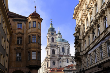 view to St. Nicholas Church, also called Kostel Svateho Mikulase, in Prague, Czech Republic, with its dome seen from Karmelitska street, in the Mala Strana District, of the old town