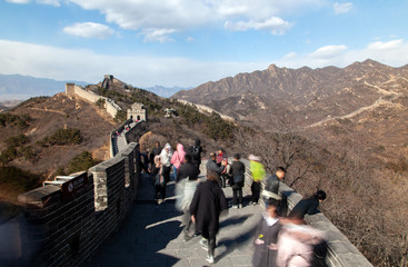 Tourists walk along large Chinese Great Wall 