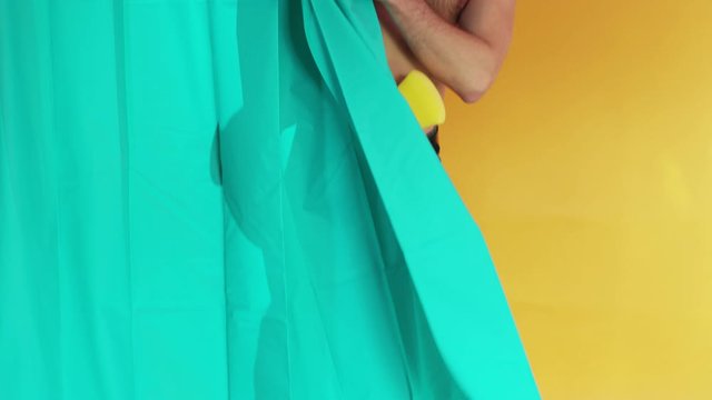 Silhouette of sexy young man taking a hot shower reflecting on green shower curtain. Unsatisfied scared transgender guy finds somebody spying him. Comical scene.