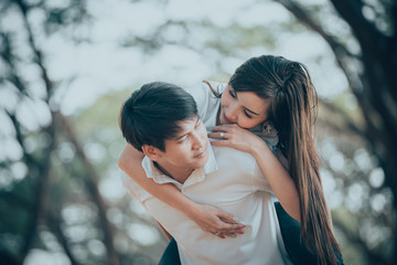 Fototapeta premium Portrait of young asian couple in love in the forest,Thailand people happy to be together,Valentine day concept