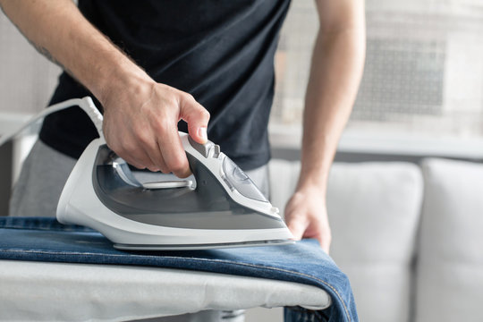 A Guy Ironing Clothes Before Going Outside