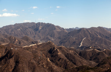 Long Chinese Great Wall on brown hilly landscape 