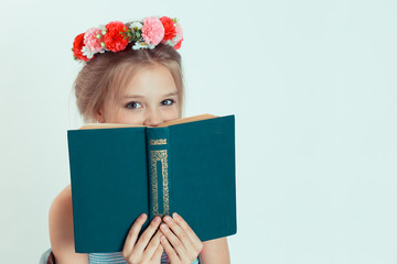 Happy beautiful  girl holding a book