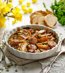 Sausage casserole with the addition of onion leeks and apple particles served in dish