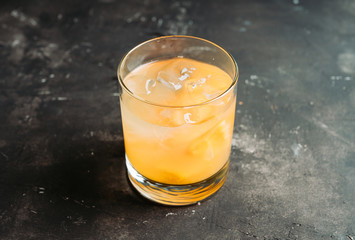 Old fahioned lemon beverage on the rustic background. Selective focus. Shallow depth of field.