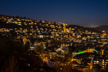 Germany, Night sky over illuminated cityscape of stuttgart heslach houses by night, aerial view above skyline