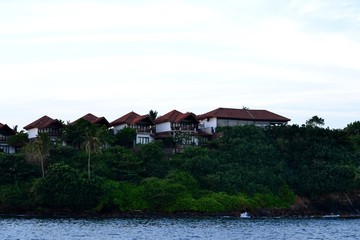 Fototapeta na wymiar Several houses on top of the ocean shore