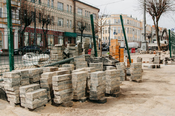 a large pile of paving stones before repair, lies folded before repair