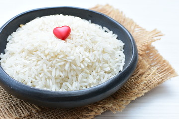 Natural raw white rice grains, on display in bowl