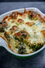 Fresh baked brocolli and cheese. Tasty food, detail, close up. 