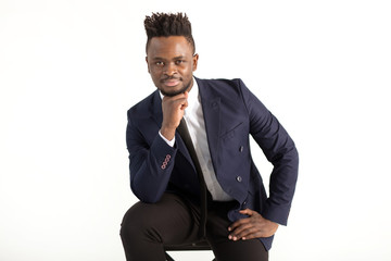 young handsome african man in a suit on a white background