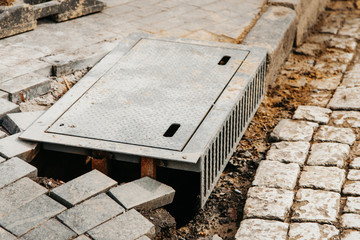 a drain hatch for metal water in the city