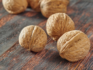 Walnut kernels on a dark table with a colored background