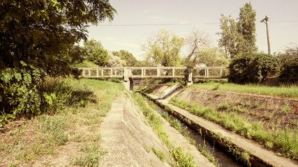 Stone Bridge Over Overgrown Canal 