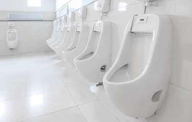 Automatic urinals in the men's bathroom. Automatic cleaning system in male toilet.