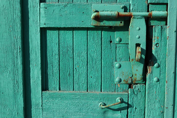 Old lock on a wooden door. Medieval door lock