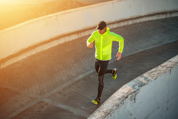 Sporty man running outdoors. Healthy lifestyle
