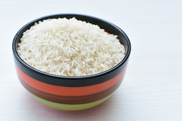 Natural raw white rice grains, on display in bowl