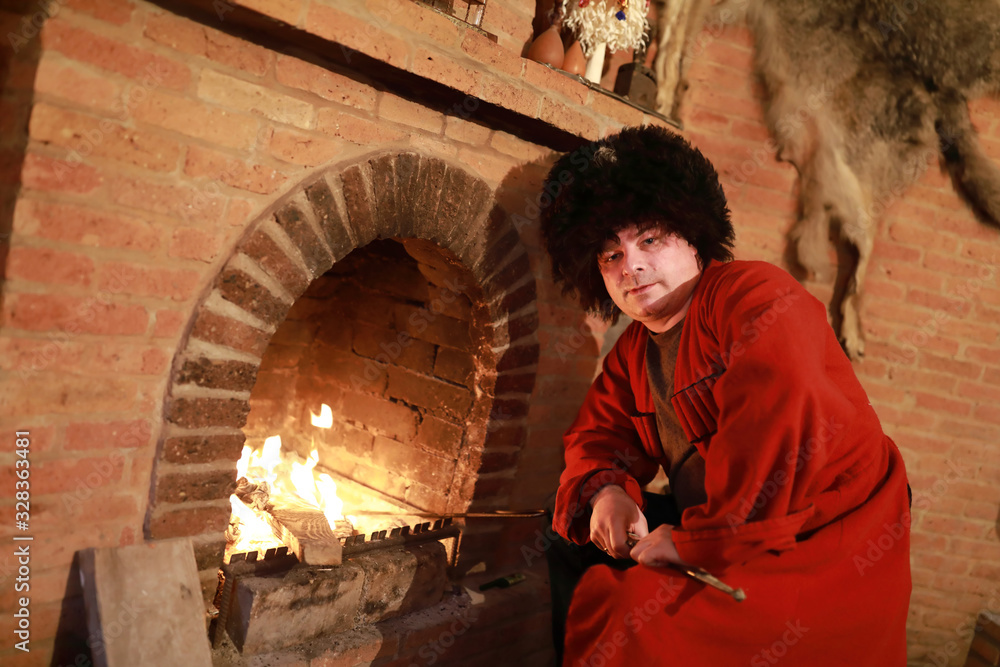 Wall mural man sitting in georgian traditional clothes