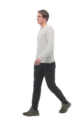 in full growth. confident young man striding forward.