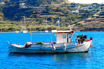 traditional fishing boat (or caique) in the small bay of Kini in Syros, famous island of Cyclades, in the heart of the Aegean Sea