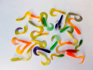Silicone multi-colored lures on white background