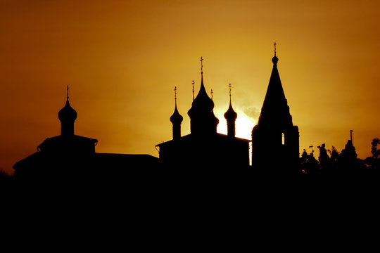 Silhouette of russian orthodox church in front of evening sun.