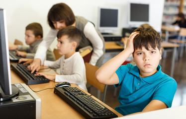 Worried boy in computer class
