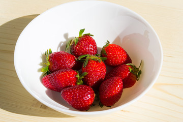 Bright strawberries on a white background, fruits and healthy food