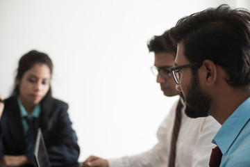 Young and energetic subordinates are discussing with female boss in Indian office.  Indian corporate.