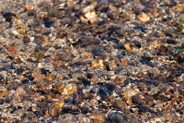 river stones under flowing water background
