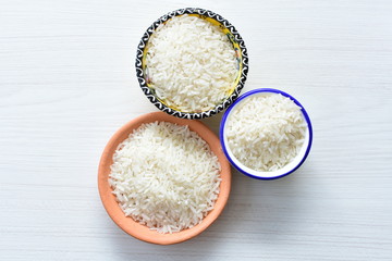 Natural raw white rice grains, on display in bowl