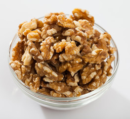 Close up of  raw peeled walnut on white background