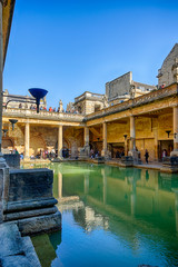 Naklejka premium BATH, ENGLAND - March 27, 2019 - The Roman baths are Bath's major tourist attraction and receive more than 1.3 million tourists every year. The city of Bath is a UNESCO World Heritage Site.
