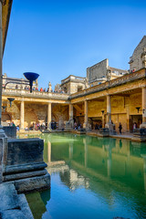 Fototapeta na wymiar BATH, ENGLAND - March 27, 2019 - The Roman baths are Bath's major tourist attraction and receive more than 1.3 million tourists every year. The city of Bath is a UNESCO World Heritage Site.