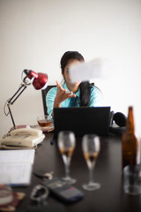 Indian Bengali attractive brunette young woman in office wear enjoying success while sitting on an office table  in a corporate office/bpo/call center. Indian corporate lifestyle.