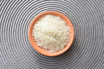 Natural raw white rice grains, on display in bowl