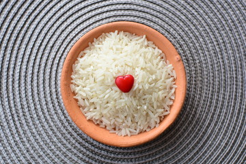 Natural raw white rice grains, on display in bowl