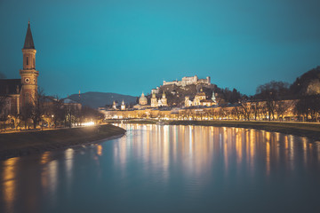 Fototapeta na wymiar Salzburg old city at dusk: Salzach, fortress Hohensalzburg and Cathedral