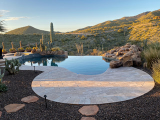 backyard pool desert mountain cactus sun setting