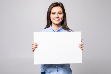 Beautiful young woman holding a blank billboard isolated on white background
