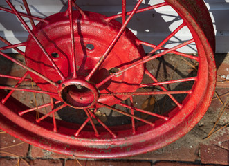 Red old wheel and rusty spokes close-up