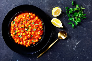 Indian vegan dish chana masala on a black plate