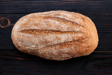 baked bread on wooden table background. Top view