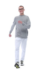 Fototapeta premium in full growth. smiling youngster in glasses goes forward