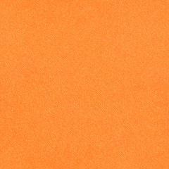 The surface texture of foamiran. Orange synthetic sponge material. Bright foam rubber background