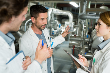 Fototapeta premium workers in lab coats working in a factory