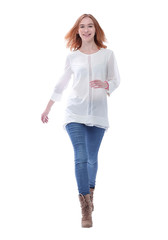 in full growth. confident young woman striding forward.