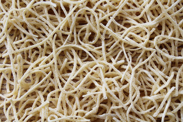 Thin dried noodles for soup. Close-up. Top view. Background. Texture.