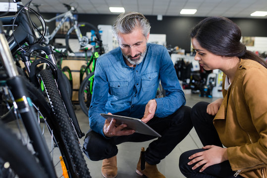 Man Use Tablet In Bike Store